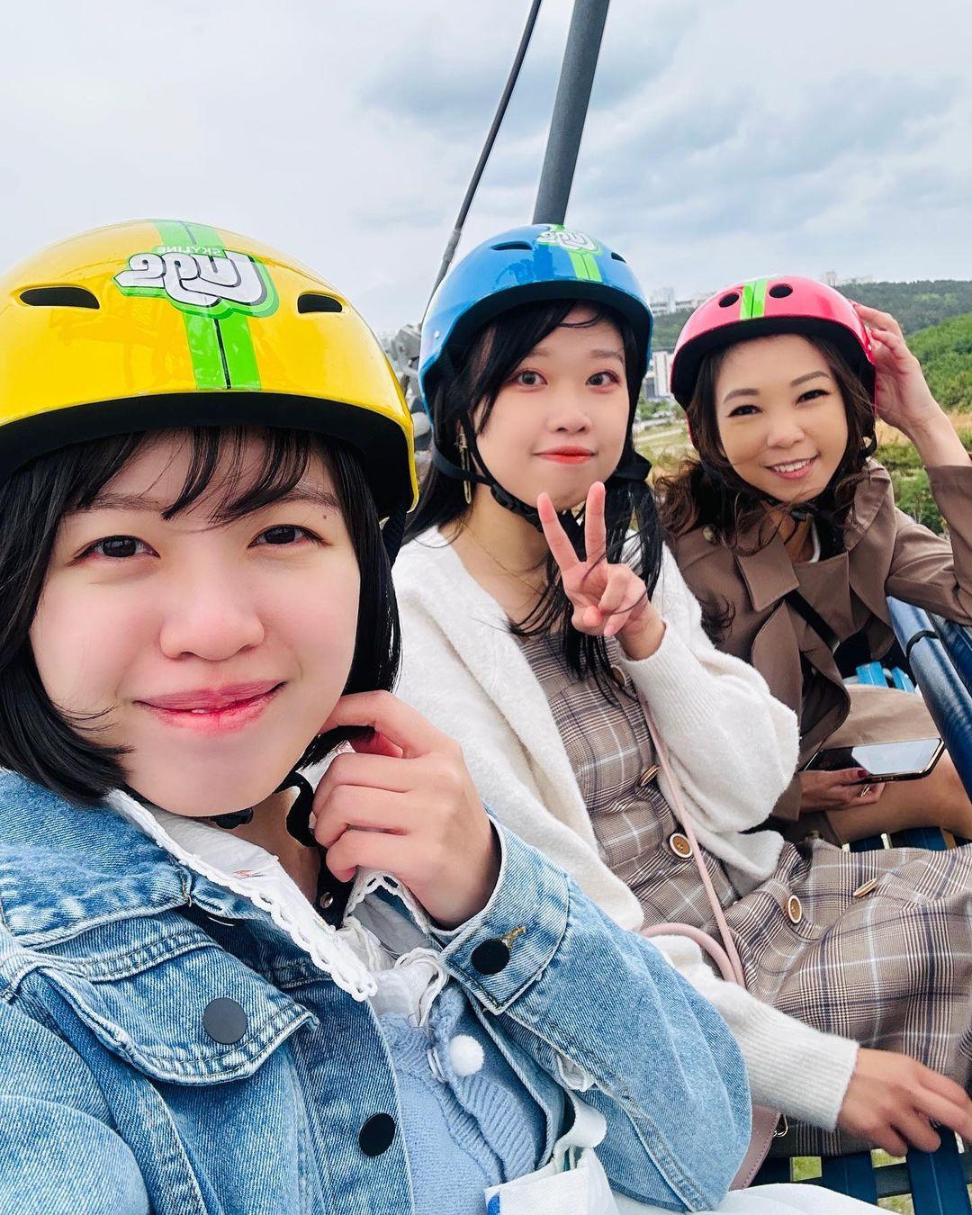 A group of friends ride the Skyride at Skyline Luge Busan.