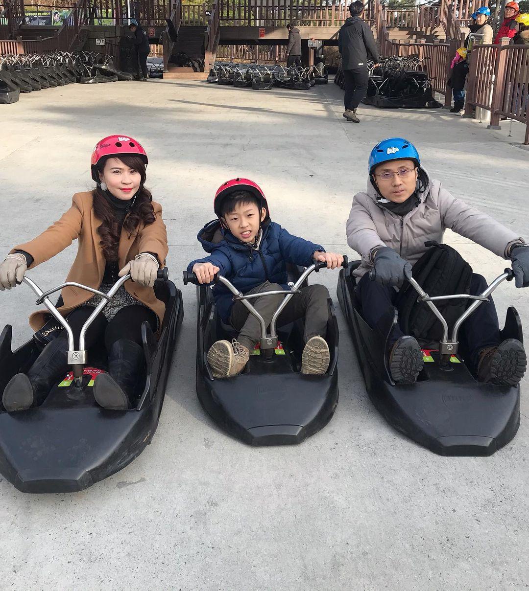 A mother and father go Luging with their son at Skyline Luge Tongyeong.