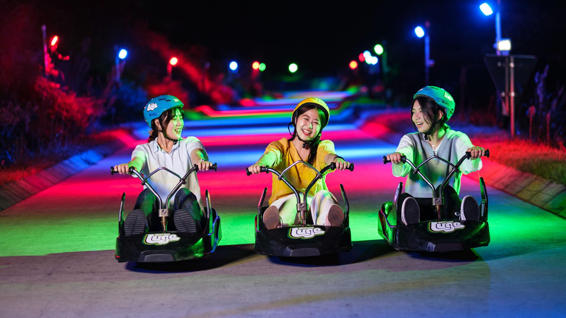 Friends enjoy the Night Luge experience together at Skyline Luge Tongyeong.